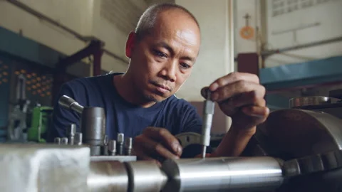 Technician asia worker using vernier caliper measure detail of workpiece Stock Footage 204054607