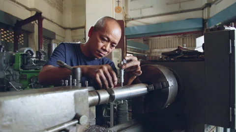 Technician asia worker using vernier caliper measure detail of workpiece Stock Footage 204054623