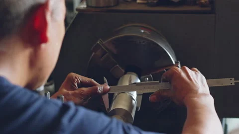 Technician asia worker using vernier caliper measure detail of workpiece Stock Footage 204054673