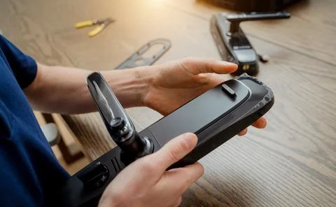 A technician assembles and installs smart electronic door lock for house Stock Photos