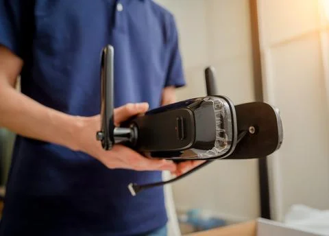 A technician assembles and installs smart electronic door lock for house Stock Photos