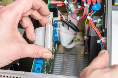 Technician assembles components of an electrical device Stock Photos