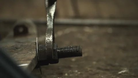 The technician assembles the machine and screws the machine mounting base Stock Footage 274874327
