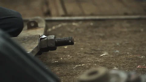 The technician assembles the machine and screws the machine mounting base Stock Footage 274875107