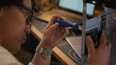 Technician Assembling Computer Tower with Screwdriver Stock Footage 338423691