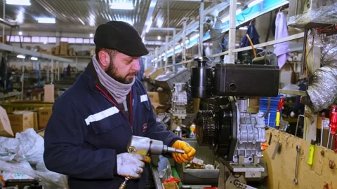 Technician Assembling Engine Component in Workshop Environment 库存影片 308043300