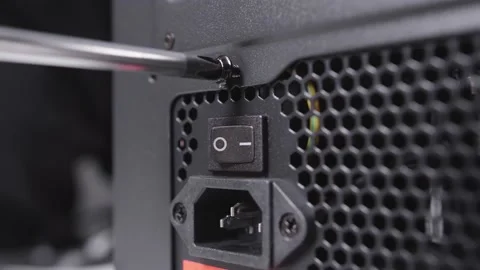 Technician assembly computer using screwdriver to instal screws of power supply Video stock 154647221