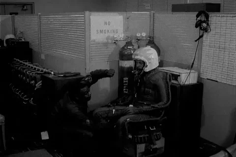 Technician attach oxygen pipe to gear of Major Richard S. Heyser - 1962 動画素材 104659409