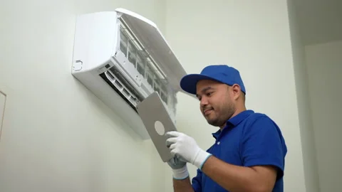 Technician in blue uniform using tablet to check list of maintenance and clean. Stock Footage 234257249