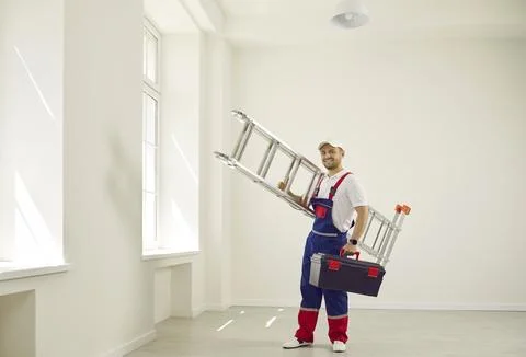 Technician came to work with high folding ladder and tool box. Stock Photos