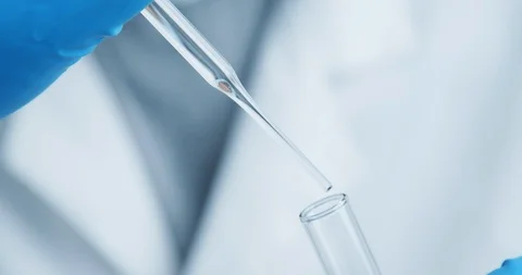 Technician carefully drips the solution from the pipette into glass tubes. Stock Footage 120834507