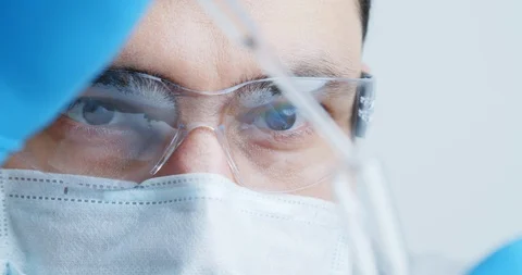 Technician carefully drips the solution from the pipette into glass tubes. Stock Footage 120836927