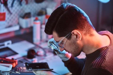 Technician carefully examines the integrity of the internal elements of the Stock Photos