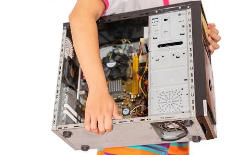 A technician carries a computer to fix it at the shop. Stock Photos