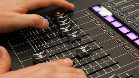 Technician changing sound panel settings at a concert event Stock Footage 125867995