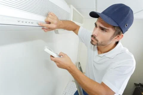 Technician checking ac installation in clients building Stock Photos