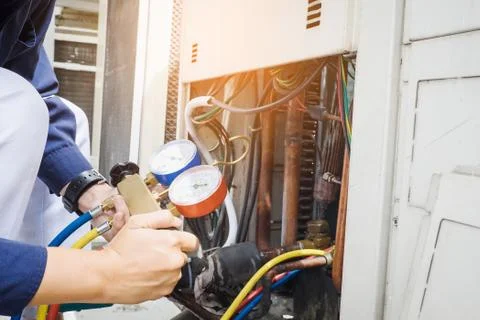 Technician is checking air conditioner Stock Photos