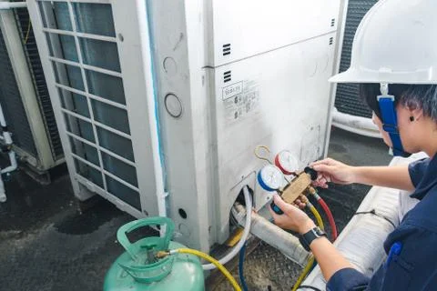 Technician is checking air conditioner Stock Photos