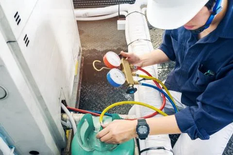 Technician is checking air conditioner Stock Photos