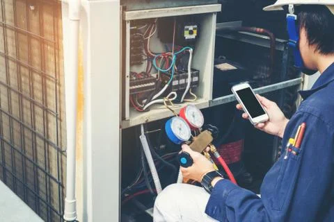 Technician is checking air conditioner Stock Photos