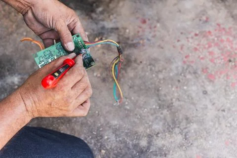 Technician is checking back side remote control motherboard. 写真素材