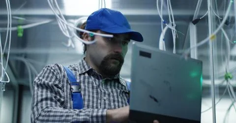 Technician checking cables in a data center Stock Photos