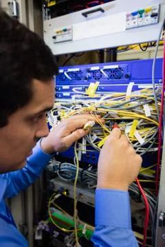 Technician checking cables in a rack mounted server Stock Photos
