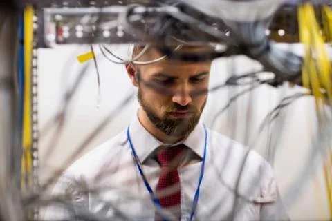 Technician checking cables in a rack mounted server Stock Photos