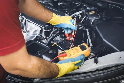 Technician checking DC voltage stable with digital multimeter Stock Photos