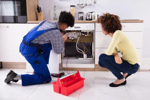 Technician Checking Dishwasher With Digital Multimeter Stock Photos