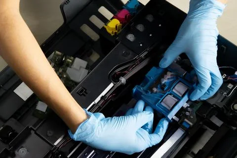 A technician is checking the printer's print head. Stock Photos