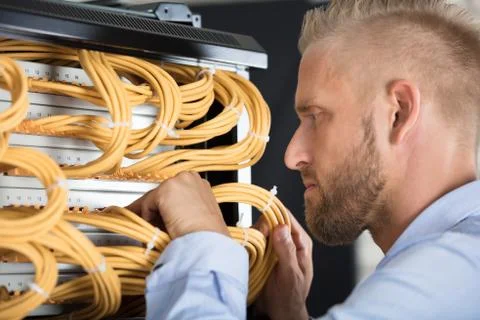 Technician Checking Server's Wires In Data Center Stock Photos