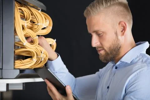 Technician Checking Server's Wires In Data Center Stock Photos