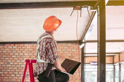 The technician is checking the signal. After installing the Internet in the b Stock Photos