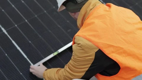 Technician checking solar panel alignment with spirit level. Stock Footage 320290229