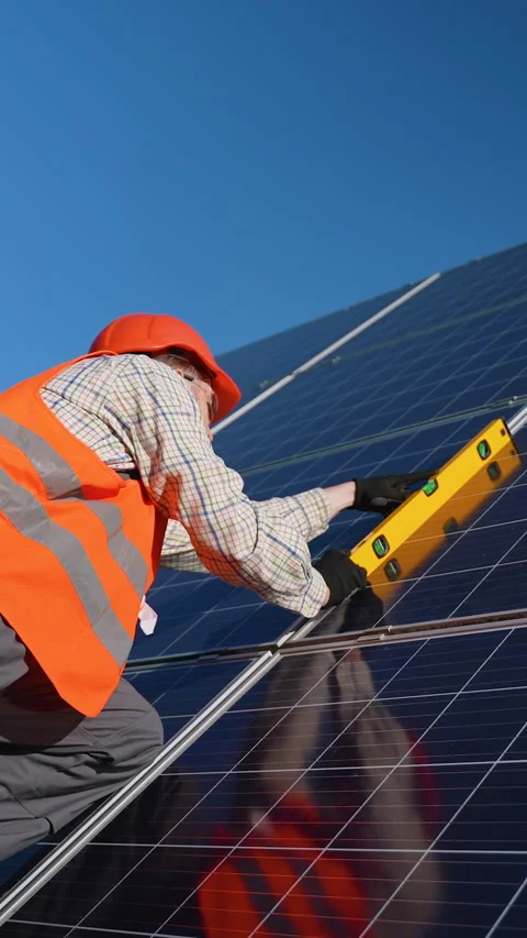 Technician checking solar panel angle with spirit level Stock Footage 314410705