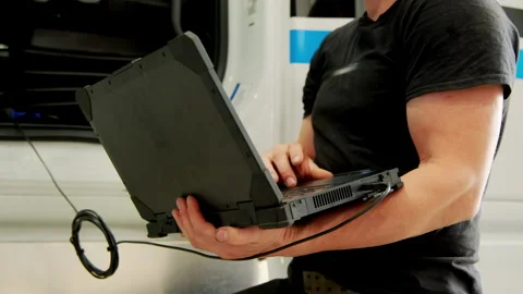 Technician checking truck systems with modern diagnostic software in r Stock Footage 304392435