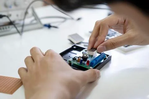 Technician checks the electronic device. Stock Photos
