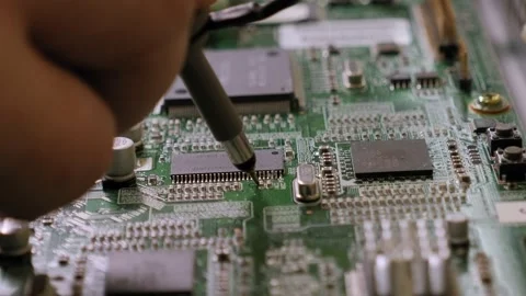 A technician checks the voltage in the motherboard while repairing the TV. Stock Footage 142077801