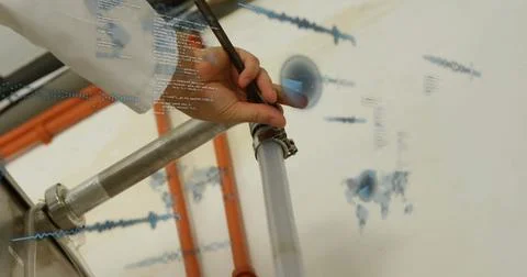 Technician clad in lab coat securing clamp on hose in laboratory, with pipe and Stockfoto's