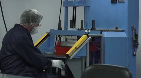 Technician in Clean Room gets up from Machine and Walks by Camera Stock Footage 10895509