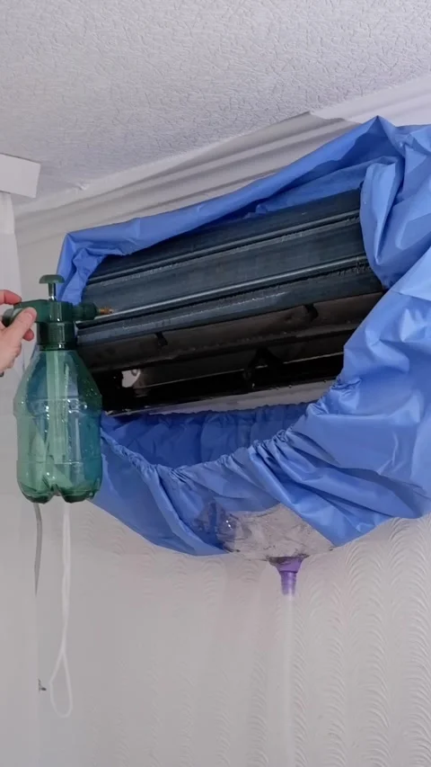 Technician cleaning air conditioner with pressure sprayer Stock Footage 338008631
