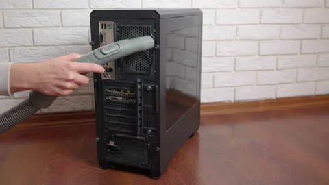 Technician cleaning desktop computer case with vacuum cleaner Stock Footage 344322071