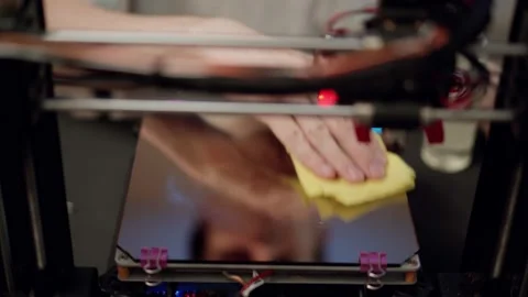 Technician cleaning part of 3D printer Stock Footage 157278157