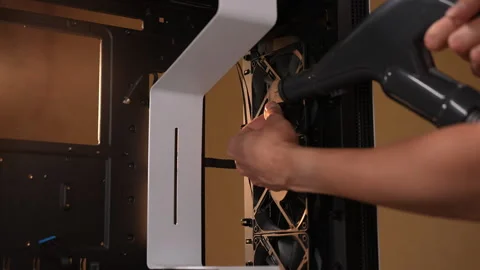 Technician cleaning personal computer using vacuum cleaner, removing dust and Stock Footage 287512636