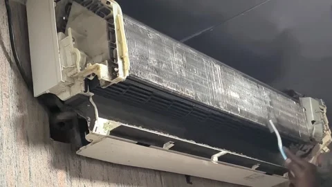 Technician cleaning split air conditioner filter with professional tools Stock Footage 334193952