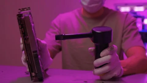 Technician cleans hardware. Worker sanitizes computer parts using compressed air Stock Footage 347877585