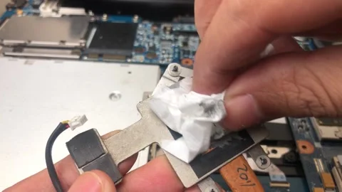 Technician cleans microprocessor heatsink from thermal paste Video stock 297700319