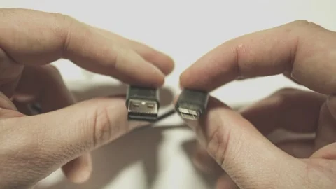 Technician comparing usb-c and usb connectors on white background Stock Footage 295217895