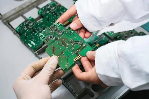 Technician with computer circuit board with chips. Spare parts and components Stock Photos